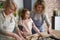 Happy three generations of women making Eater cookies at home