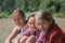 Happy three teen girlfriends on the beach after river swimming