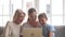 Happy three women generation family watching cartoons on laptop