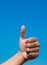 Happy thumb on blue background