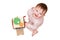 Happy toddler baby boy is playing with a busyboard cube on the nurser