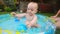 Happy toddler boy having fun in pool at garden