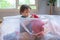 Happy toddler boy playing in a laundry basket