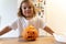 Happy toddler child with carved pumpkin at home. Halloween activities with kids