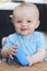 Happy Toddler With Empty Bowl Sitting At Table