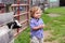 Happy Toddler at Farm with Baby Goat