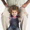 Happy toddler girl holding father on shoulders