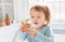 Happy toddler girl playing with potted plants