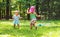 Happy toddler girls playing in a sprinkler