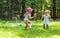 Happy toddler girls playing in a sprinkler