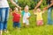 Happy toddlers learn to walk holding mothers hands