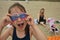 Happy toothless girl on a beach in Romania with goggles