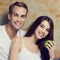 Happy toothy smiling couple with apple. Vegetarian, weight losing, dieting, healthy food, dental health