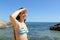 Happy tourist in bikini scouting on the beach