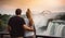 Happy tourist couple enjoying the view to Niagara Falls during romantic vacation. Generative AI