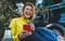 Happy tourist laughing communication on cellphone drinks tea while traveling auto. Young woman smiles showing teeth calling