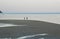 Happy tourist silhouette enjoying morning beach walk