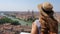 Happy tourist in straw hat and backpack enjoys vacation. Old town with river in Verona, Italy.