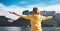 Happy tourist traveler stand with raised hands, girl hiker enjoying mountains lake with arms outstretched breathing of fresh