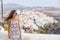 Happy tourist woman walking in Oia, Santorini, Greece vacation. Europe summer holiday destination