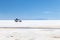 Happy tourists enjoy Jeep tour activities in Salt flats Salar de Uyuni in Bolivia