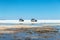 Happy tourists enjoy Jeep tour activities in Salt flats Salar de Uyuni in Bolivia