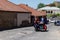 Happy tourists riding all terrain vehicle on street of the medieval town Sighnaghi