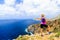 Happy trail runner woman looking at mountains