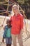 Happy trainer and girl standing together at school playground