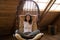 Happy tranquil Hispanic woman relaxing in country house eco wooden