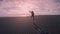 Happy travel blogger woman runs on sunset beach