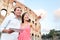 Happy travel couple with tablet by Coliseum, Rome