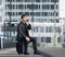 Happy travel man talking on mobile phone while sitting on suitcase