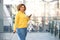 Happy travel woman with cellphone at station