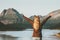 Happy Travel Woman tourist hands raised enjoying Norway sunset mountains and sea landscape Lifestyle concept adventure v