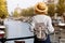 Happy traveler girl enjoying Amsterdam city. Tourist woman looking to the Amsterdam canal, Netherlands, Europe