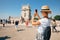 Happy traveler girl in Lisbon near Belem Tower. Tourist woman taking picture of Belem Tower, Portugal