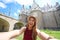 Happy traveler girl taking selfie photo with Nantes Castle on the background, France