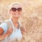 Happy traveler girl in wheat field