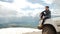 Happy Traveler man sitting on his car on mountains top. 4x4 travel trekking