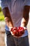 Happy traveler relaxes with a ripe pomegranate in his hands