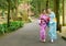 Happy traveler women walking on tree path in japan