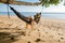 Happy traveler womn in hammock relaxing on swing and looking beautiful nature landscape , Andaman sea, Krabi, Tourist