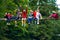 Happy travelers, friends sit on the suspension bridge