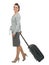 Happy traveling woman with suitcase walking sidewa