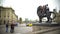 Happy travellers sitting on bronze lion sculpture, posing for funny selfie