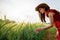 Happy travelling tourists concept young asian beautiful woman wearing red dress enjoying herself in the barley farm