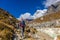 Happy trekker girl hiking in the mountains of Nepal