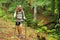 Happy trekker walking in a forest