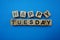 Happy Tuesday text alphabet letter on blue background